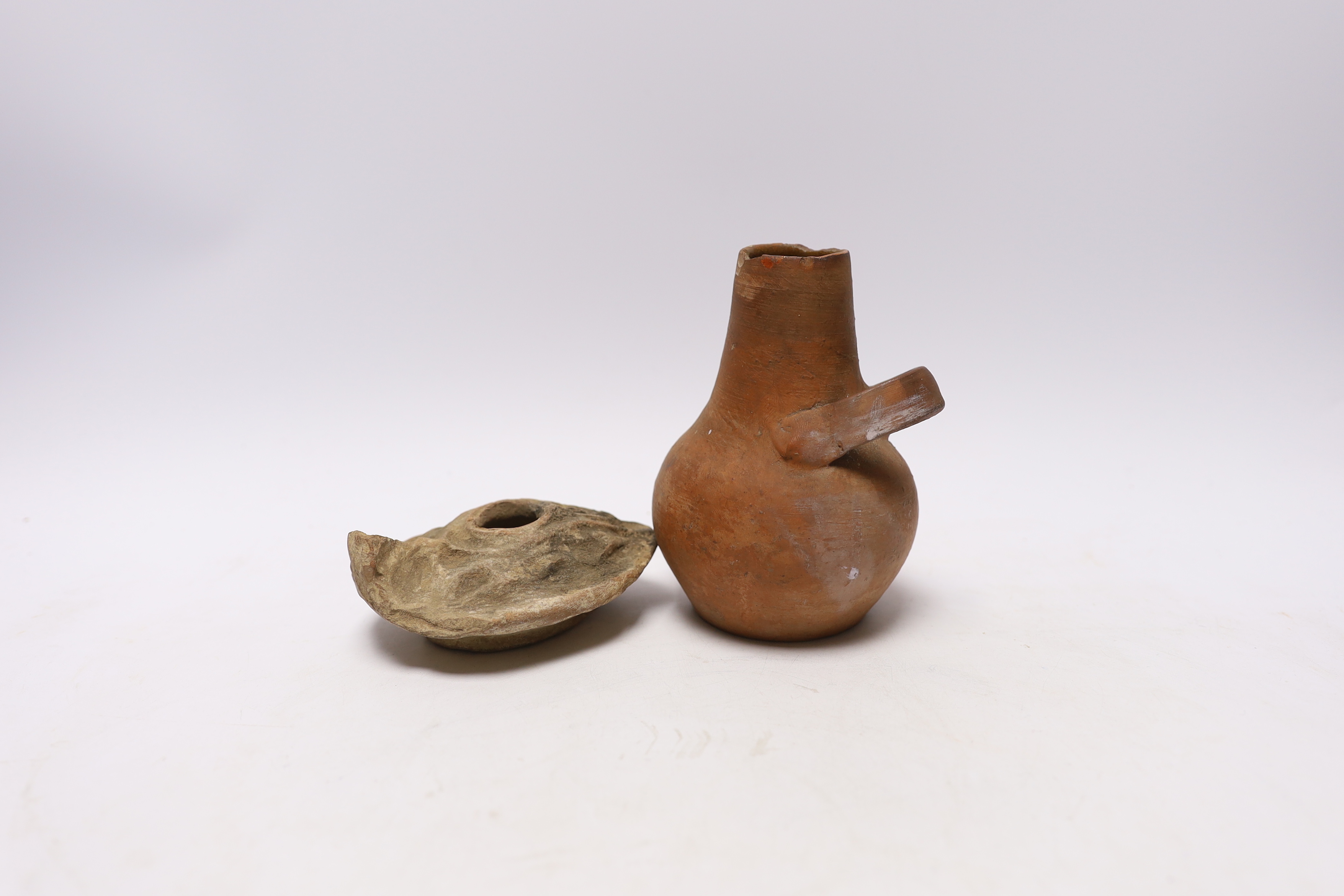 A Roman lamp, possibly 3rd century and an ancient pot, 12.5cm high